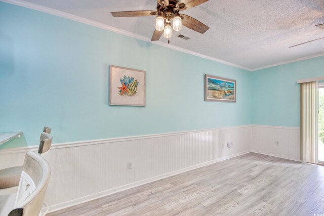 130 Scotch Broom Dr Unit H-103, Little River, SC 29566 - empty room featuring ceiling fan, visible vents, ornamental molding, wainscoting, and wood finished floors