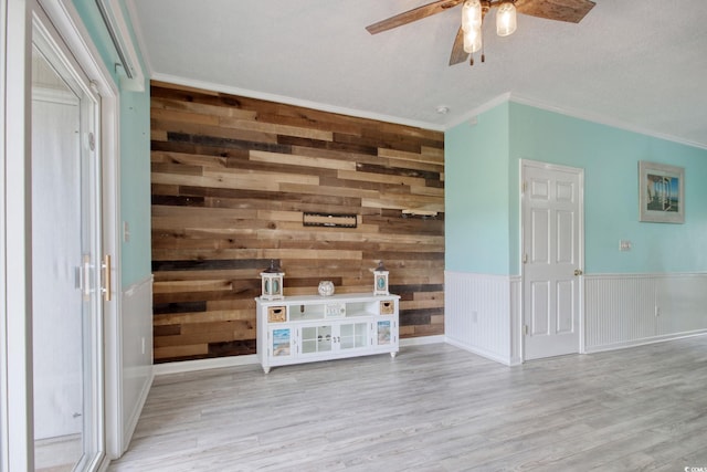 130 Scotch Broom Dr Unit H-103, Little River, SC 29566 - unfurnished living room with wood finished floors, ceiling fan, wooden walls, and ornamental molding