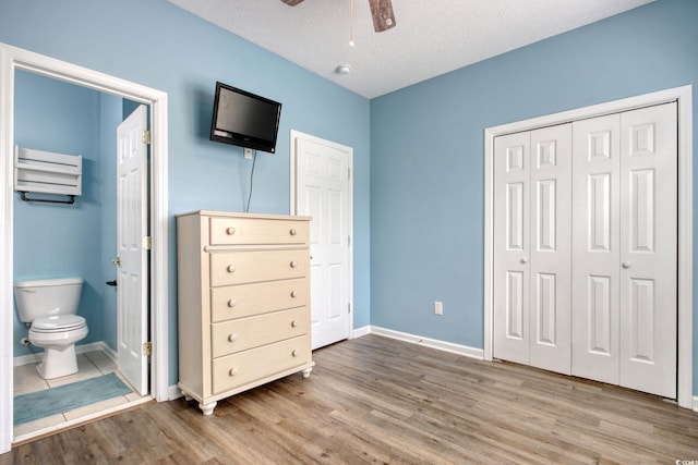 130 Scotch Broom Dr Unit H-103, Little River, SC 29566 - bedroom featuring baseboards, wood finished floors, connected bathroom, and a closet