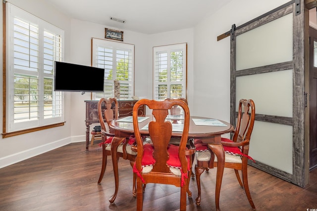 221 Lander Dr, Conway, SC 29526 - dining room featuring a barn door, baseboards, and wood finished floors