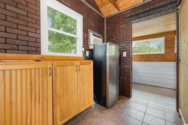 221 Lander Dr, Conway, SC 29526 - kitchen featuring freestanding refrigerator, brick wall, and an AC wall unit