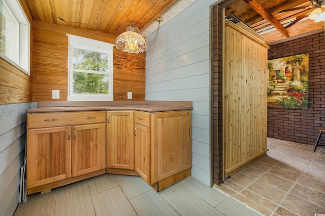 221 Lander Dr, Conway, SC 29526 - kitchen featuring wood walls, wooden ceiling, brick wall, a chandelier, and hanging light fixtures