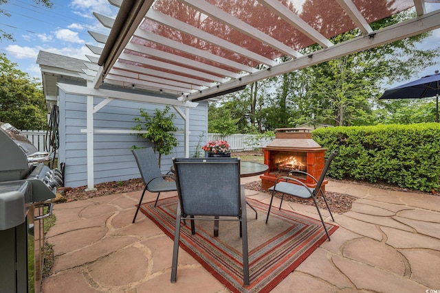 221 Lander Dr, Conway, SC 29526 - fenced backyard featuring a patio area, outdoor dining space, a warm lit fireplace, and a pergola