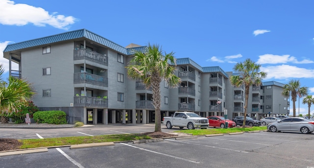 view of building exterior with uncovered parking