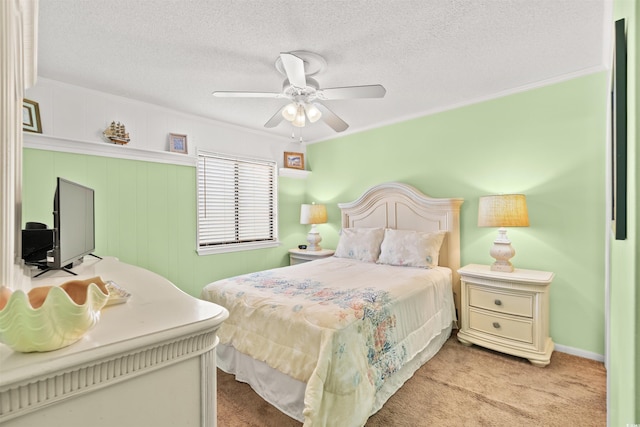 bedroom featuring a textured ceiling, ornamental molding, and carpet