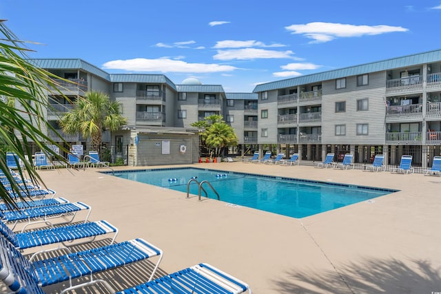 pool featuring a patio area and fence