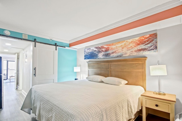 7200 Ocean Blvd N Unit 664, Myrtle Beach, SC 29572 - bedroom with a barn door, wood finished floors, and baseboards