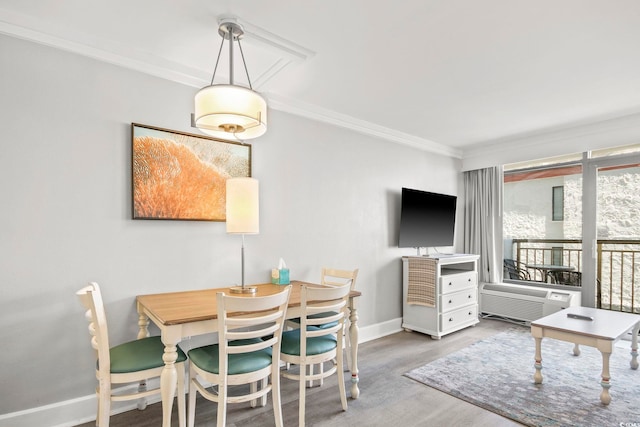 7200 Ocean Blvd N Unit 664, Myrtle Beach, SC 29572 - dining area featuring baseboards, ornamental molding, wood finished floors, and a wall mounted AC