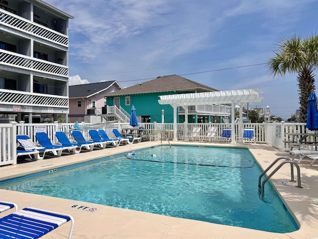 pool featuring a pergola and fence