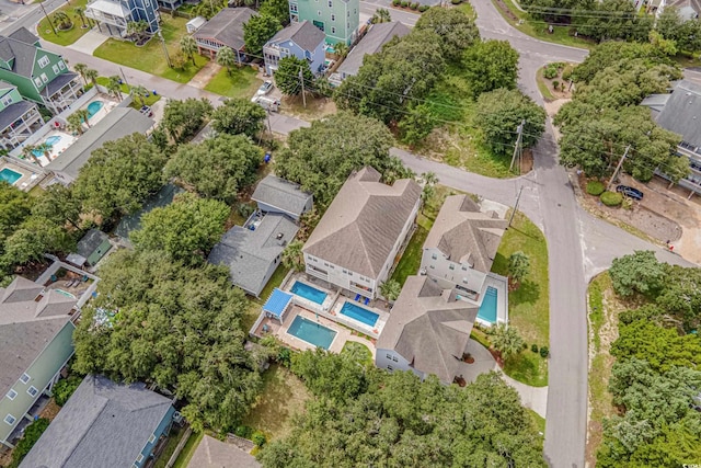 view of property location with a pool area and nearby suburban area
