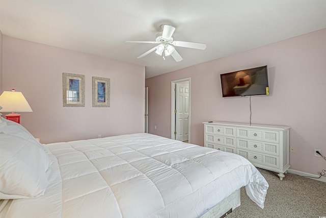 bedroom featuring light colored carpet, ceiling fan, and baseboards