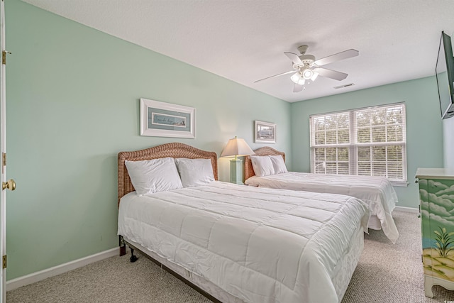 bedroom featuring carpet flooring, visible vents, baseboards, and ceiling fan