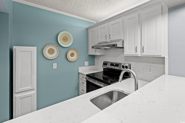 kitchen featuring stainless steel electric stove, light stone counters, under cabinet range hood, and a textured ceiling