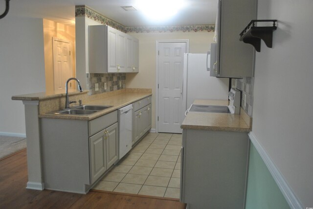 22 Woodhaven Dr Unit C, Murrells Inlet, SC 29576 - kitchen featuring a sink, dishwasher, tasteful backsplash, stove, and light wood finished floors
