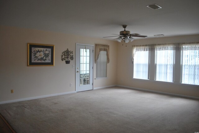 22 Woodhaven Dr Unit C, Murrells Inlet, SC 29576 - carpeted empty room featuring plenty of natural light, baseboards, and ceiling fan