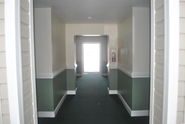 22 Woodhaven Dr Unit C, Murrells Inlet, SC 29576 - hallway with baseboards and dark carpet
