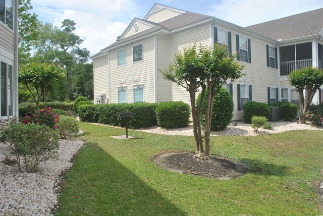 22 Woodhaven Dr Unit C, Murrells Inlet, SC 29576 - view of property exterior featuring a lawn and central air condition unit