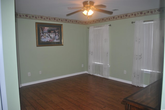 22 Woodhaven Dr Unit C, Murrells Inlet, SC 29576 - empty room with dark wood-style flooring, a ceiling fan, and baseboards