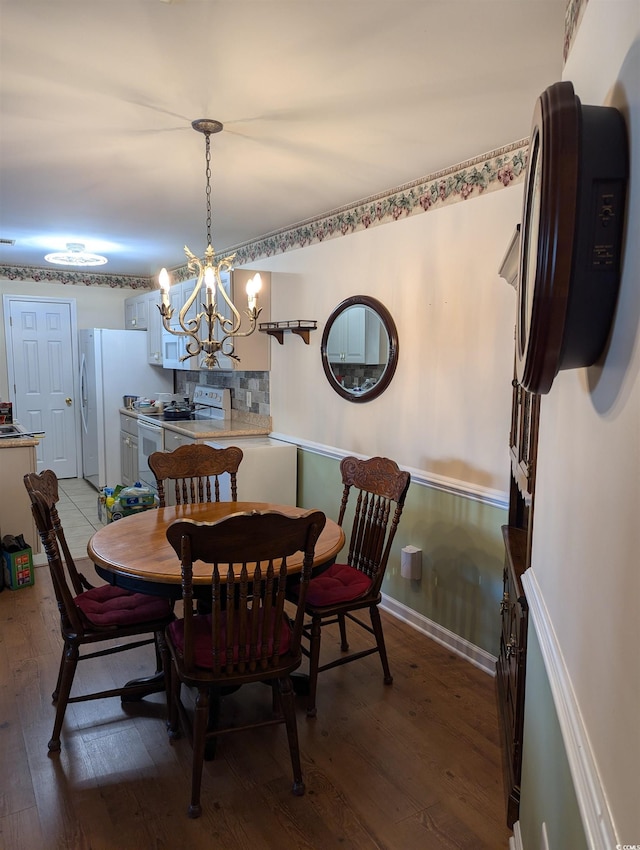 22 Woodhaven Dr Unit C, Murrells Inlet, SC 29576 - dining room featuring light wood-style floors, baseboards, and a notable chandelier