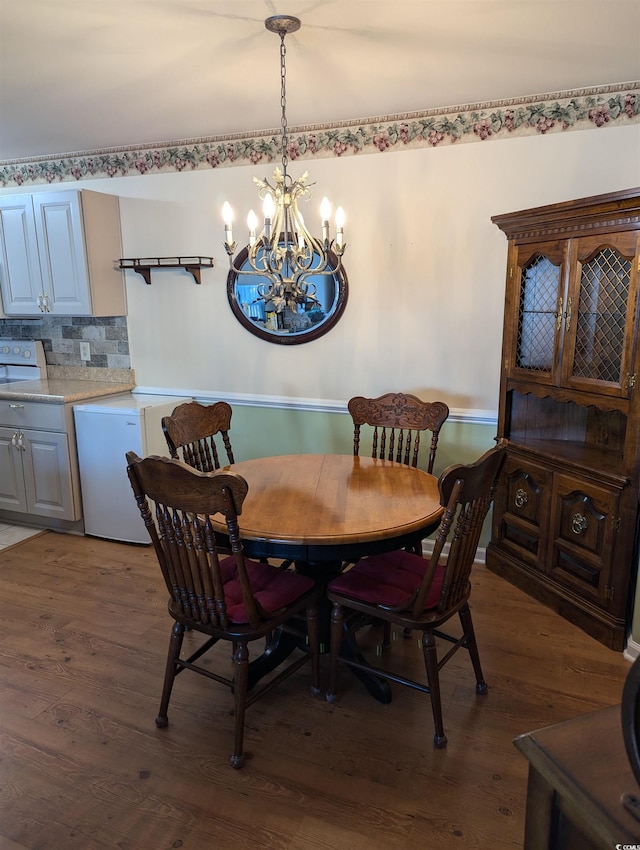 22 Woodhaven Dr Unit C, Murrells Inlet, SC 29576 - dining space with an inviting chandelier and dark wood finished floors