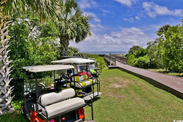 view of property's community featuring a water view and a yard