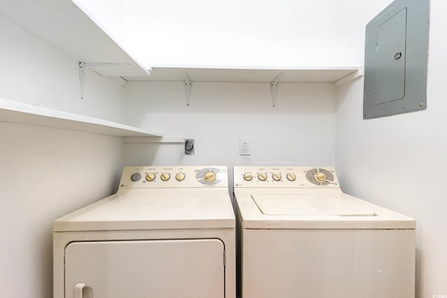 washroom with separate washer and dryer, electric panel, and laundry area