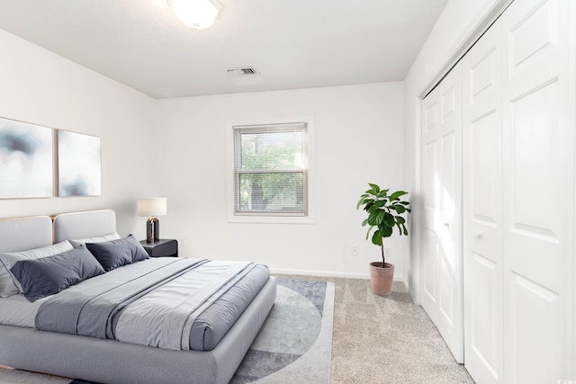carpeted bedroom featuring a closet and baseboards