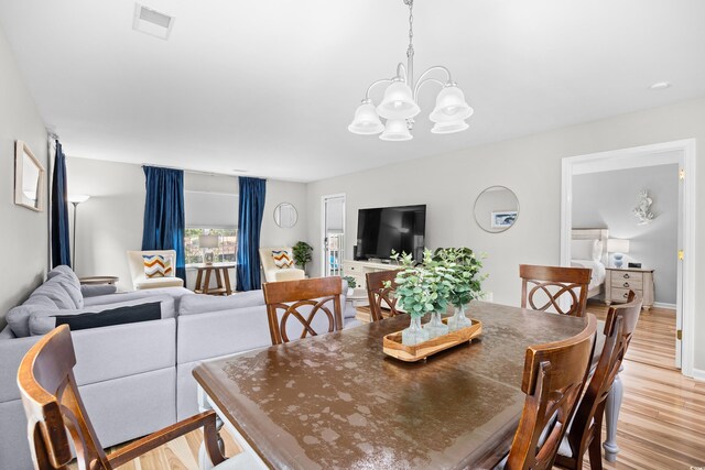 1204 River Oak Dr Unit 25-A, Myrtle Beach, SC 29579 - dining space with light wood-type flooring and a chandelier