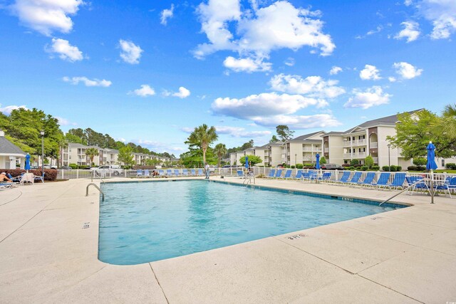 1204 River Oak Dr Unit 25-A, Myrtle Beach, SC 29579 - community pool with a residential view, fence, and a patio