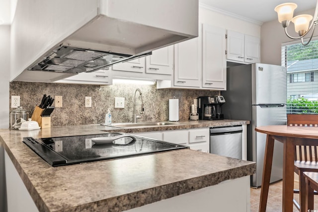 kitchen with white cabinetry, decorative backsplash, freestanding refrigerator, a sink, and ventilation hood