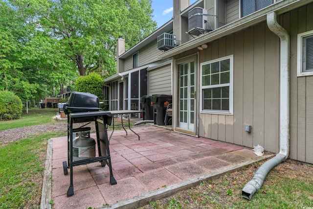 view of patio featuring central air condition unit, a balcony, and a sunroom