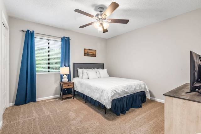 bedroom featuring baseboards, ceiling fan, carpet floors, and a closet