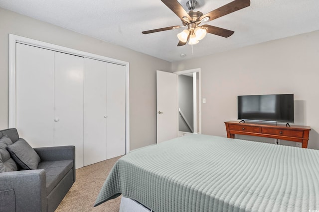 carpeted bedroom with a closet and a ceiling fan
