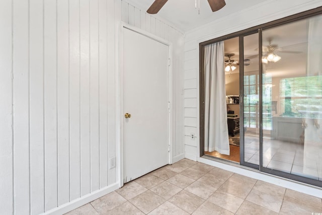 unfurnished room featuring ornamental molding, ceiling fan, and light tile patterned floors