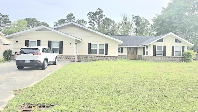 ranch-style house featuring brick siding, a front lawn, and driveway