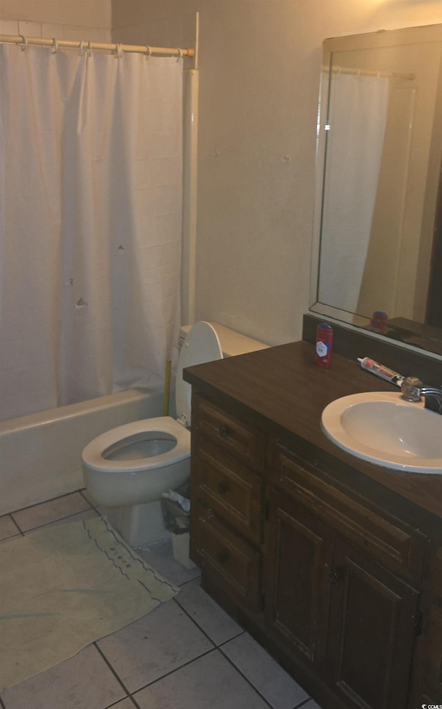bathroom featuring tile patterned floors, toilet, vanity, and shower / bath combination with curtain