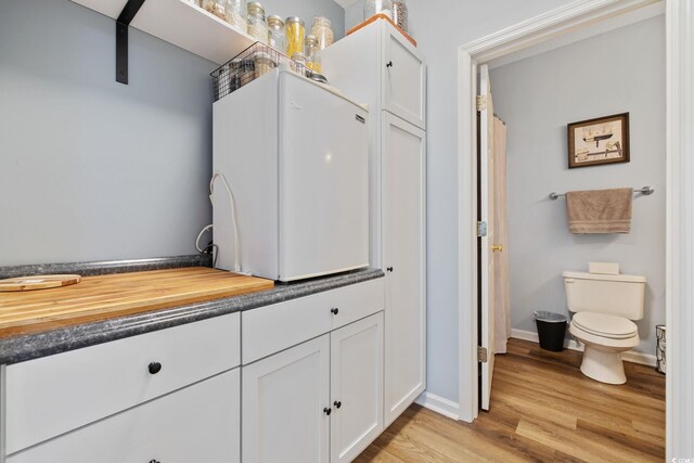2090 Cross Gate Blvd Unit 202, Surfside Beach, SC 29575 - full bathroom with wood finished floors, toilet, and baseboards