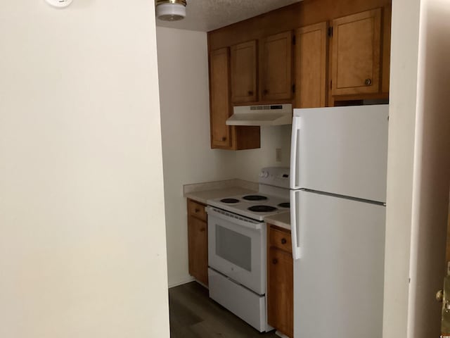 409 Salt Marsh Cir Unit 20C, Pawleys Island, SC 29585 - kitchen featuring light countertops, dark wood finished floors, under cabinet range hood, and white appliances