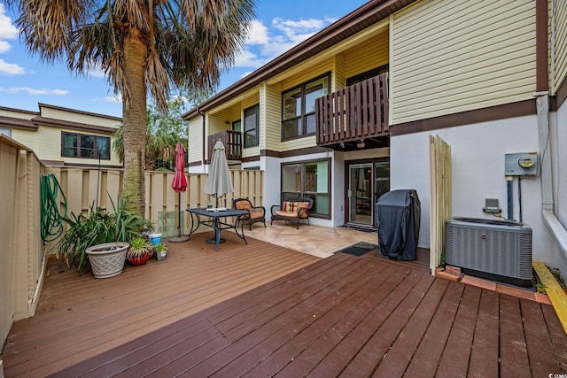 wooden terrace with central air condition unit, grilling area, and fence