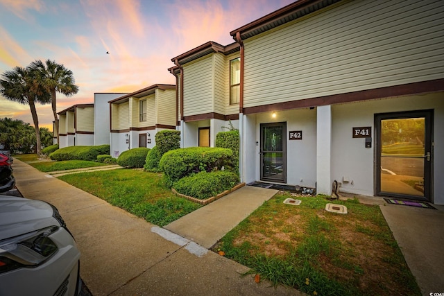 exterior space featuring a lawn and stucco siding