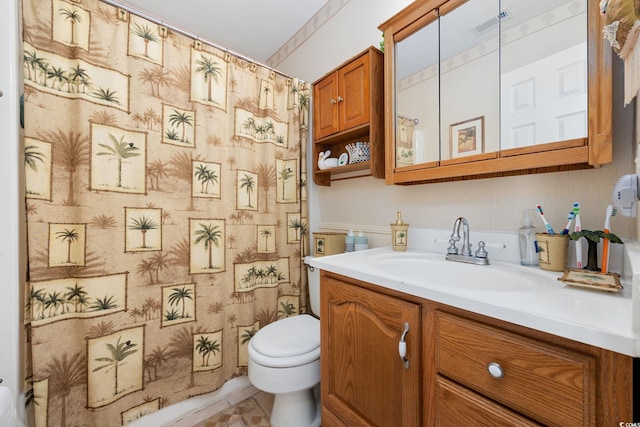 bathroom featuring toilet, visible vents, curtained shower, and vanity