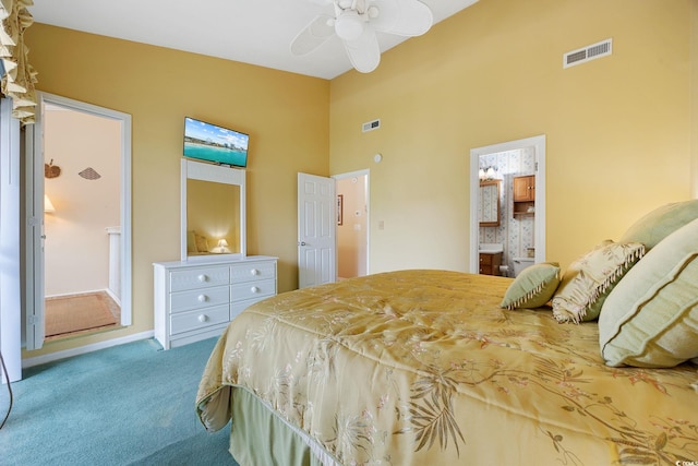 bedroom with carpet flooring, visible vents, connected bathroom, and a towering ceiling
