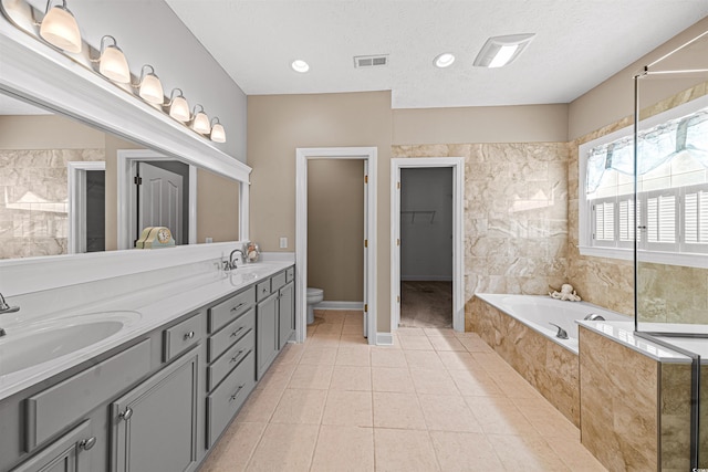 246 Laurel Bay Dr, Murrells Inlet, SC 29576 - full bathroom with a sink, tile patterned flooring, toilet, a textured ceiling, and a bath