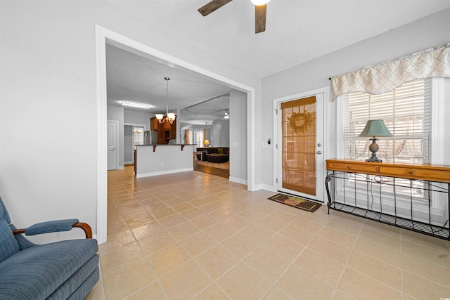 246 Laurel Bay Dr, Murrells Inlet, SC 29576 - foyer featuring light tile patterned floors, baseboards, plenty of natural light, and ceiling fan with notable chandelier