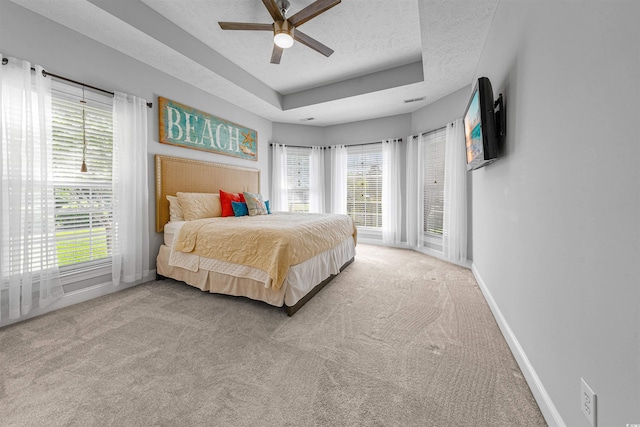 246 Laurel Bay Dr, Murrells Inlet, SC 29576 - bedroom with baseboards, multiple windows, and a tray ceiling