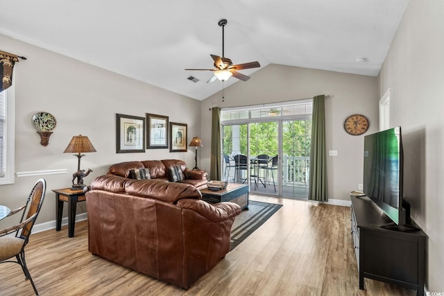 living area with light wood-style floors, a ceiling fan, baseboards, vaulted ceiling, and visible vents