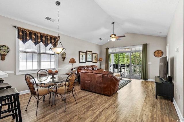 dining area with visible vents, wood finished floors, lofted ceiling, baseboards, and ceiling fan