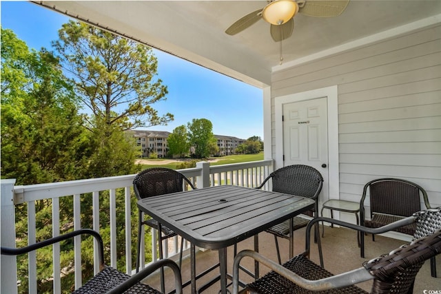 balcony featuring ceiling fan and outdoor dining space