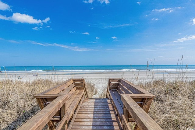 surrounding community featuring a beach view and a water view