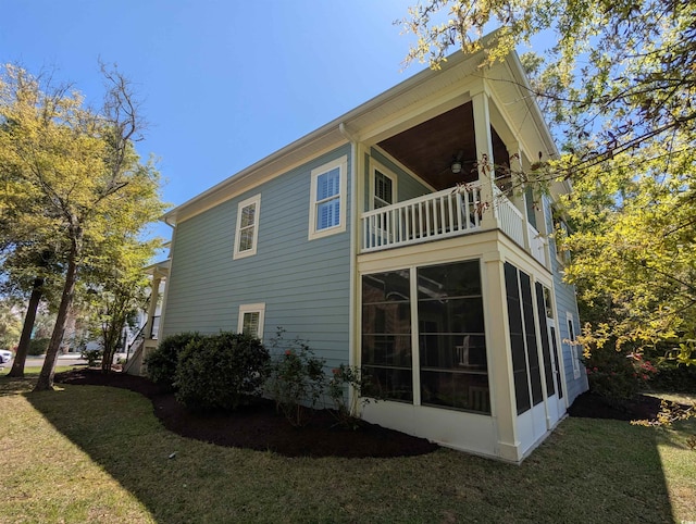 18 Trigger Fish Ln, Murrells Inlet, SC 29576 - view of property exterior with a sunroom, a ceiling fan, a yard, and a balcony